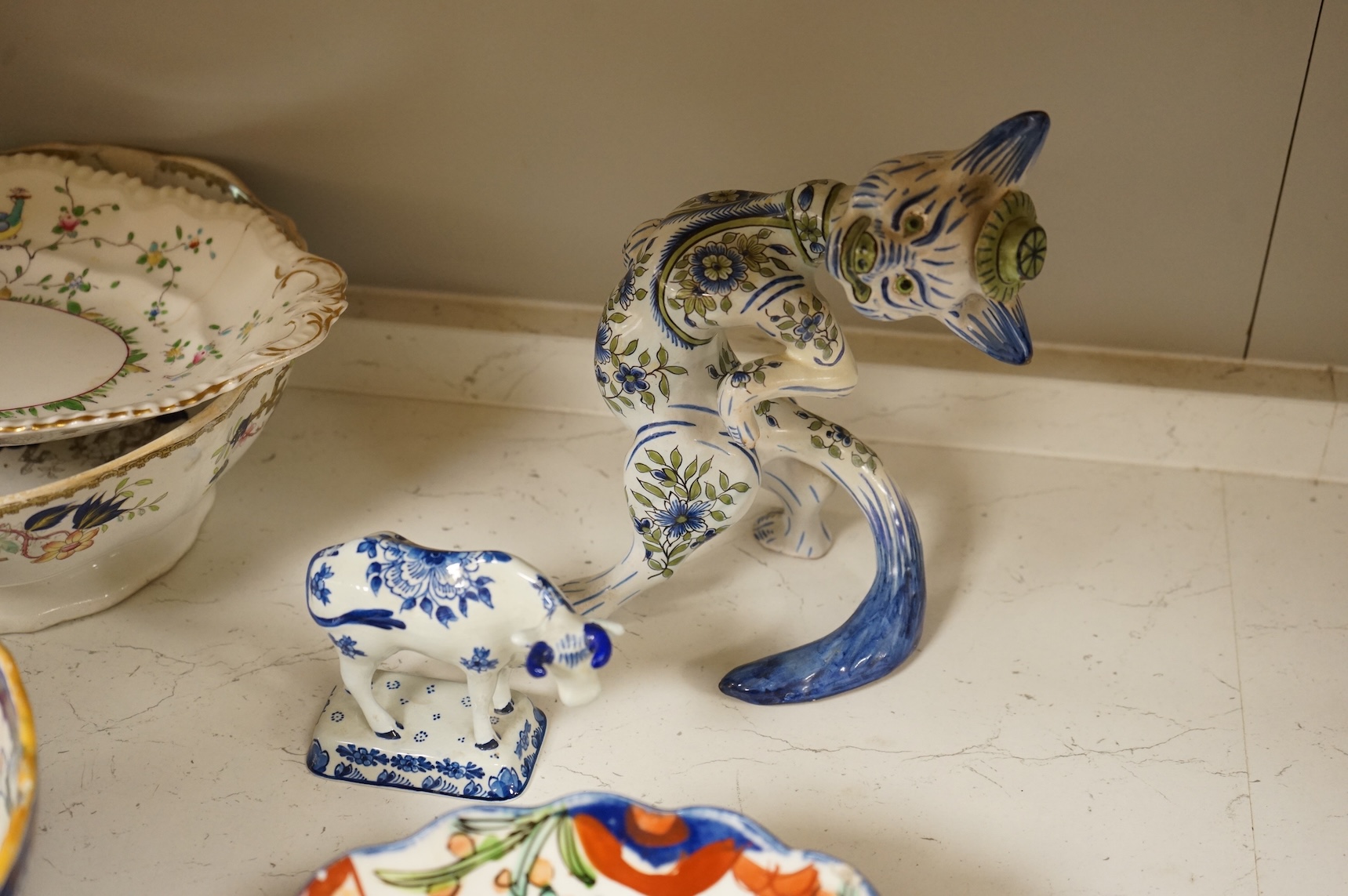 A collection of French, Japanese and English ceramics to include Royal Doulton Dickensware, Imari bowls and a faience glazed cat